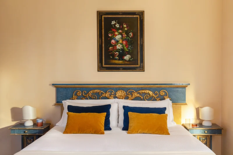 Deluxe room detail with king-size bed, elegant headboard and refined furnishings in the heart of Tuscany - La Collegiata, BZAR hotels in Tuscany