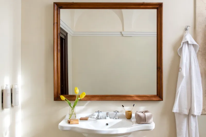 Superior room bathroom with classic sink, large mirror and courtesy set in refined Tuscan hospitality style - La Collegiata, BZAR hotels in Tuscany
